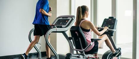 A gym with treadmills and an elliptical machine.