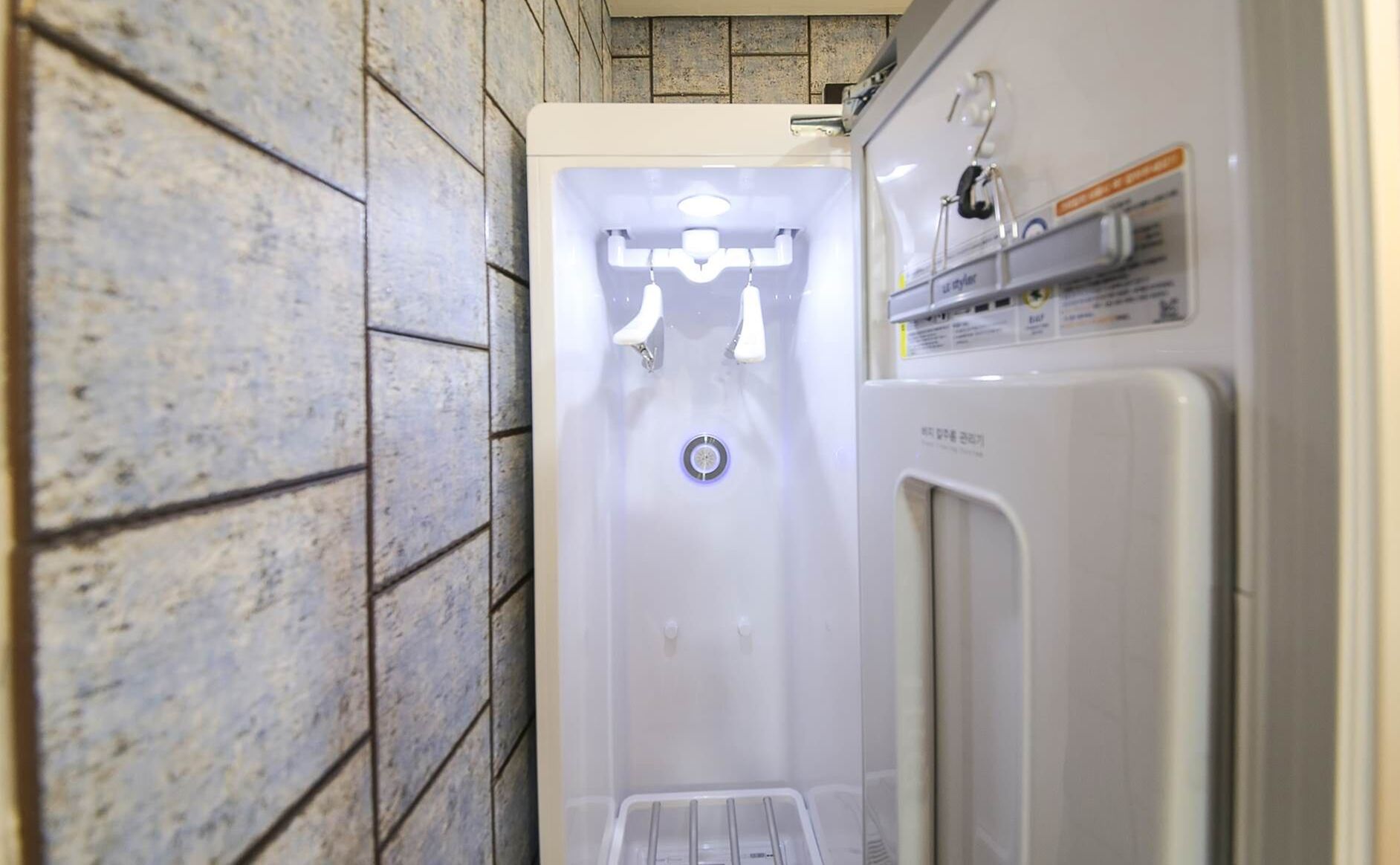 A bathroom with a shower, a toilet, and a sink.