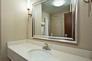 A bathroom with a white sink, a mirror, and a shower area. - Holiday Inn Express & Suites Springfield - Dayton Area by IHG (Springfield)