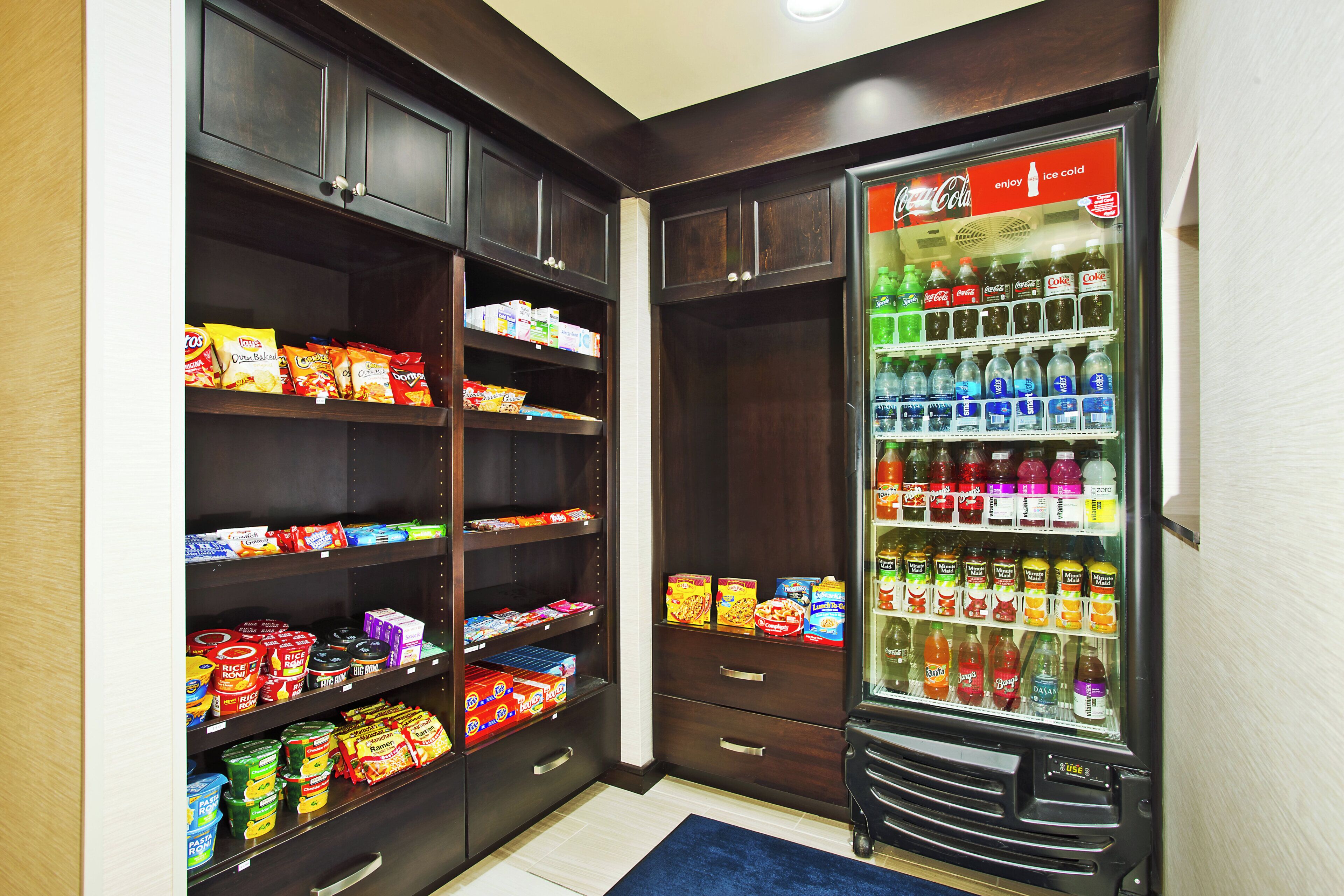 A pantry stocked with snacks, condiments, and a beverage dispenser.