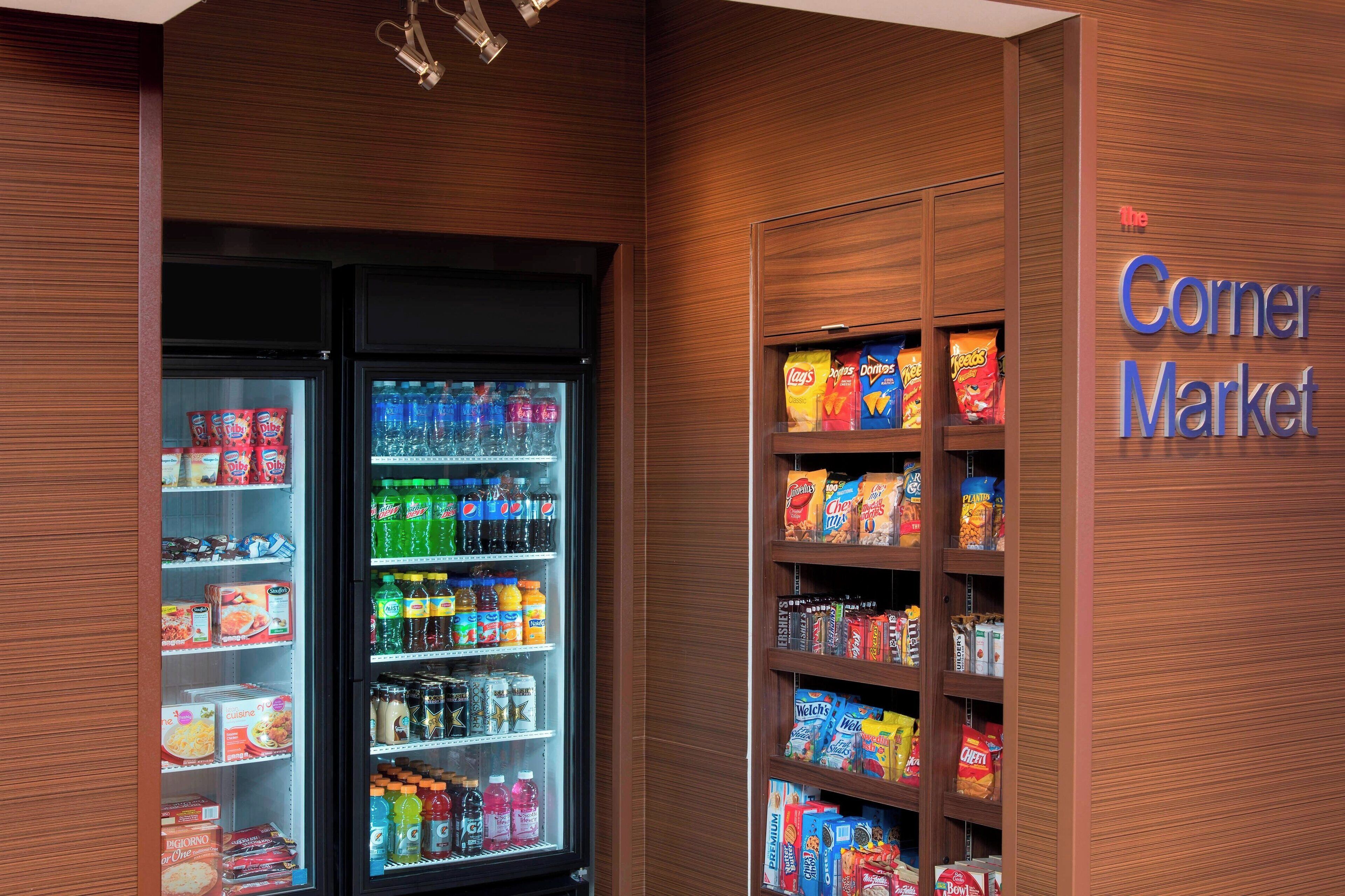 A Corner Market with refrigerated and shelf-stored food items.