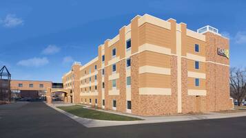 A multi-story hotel with a brick facade and a sign reading "Home2".