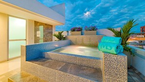 A spa area with a hot tub, steps leading up to it, and a view of the sky. - Hotel MS Ciudad Jardín Plus (Cali)