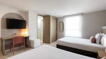 A modern hotel room with a large bed, a desk with a chair, a television, a mirror, and a window.