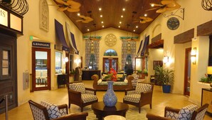 A lobby with a central seating area, a reception desk, and a sales office. - Paradise Palms Resort Orlando (Kissimmee)