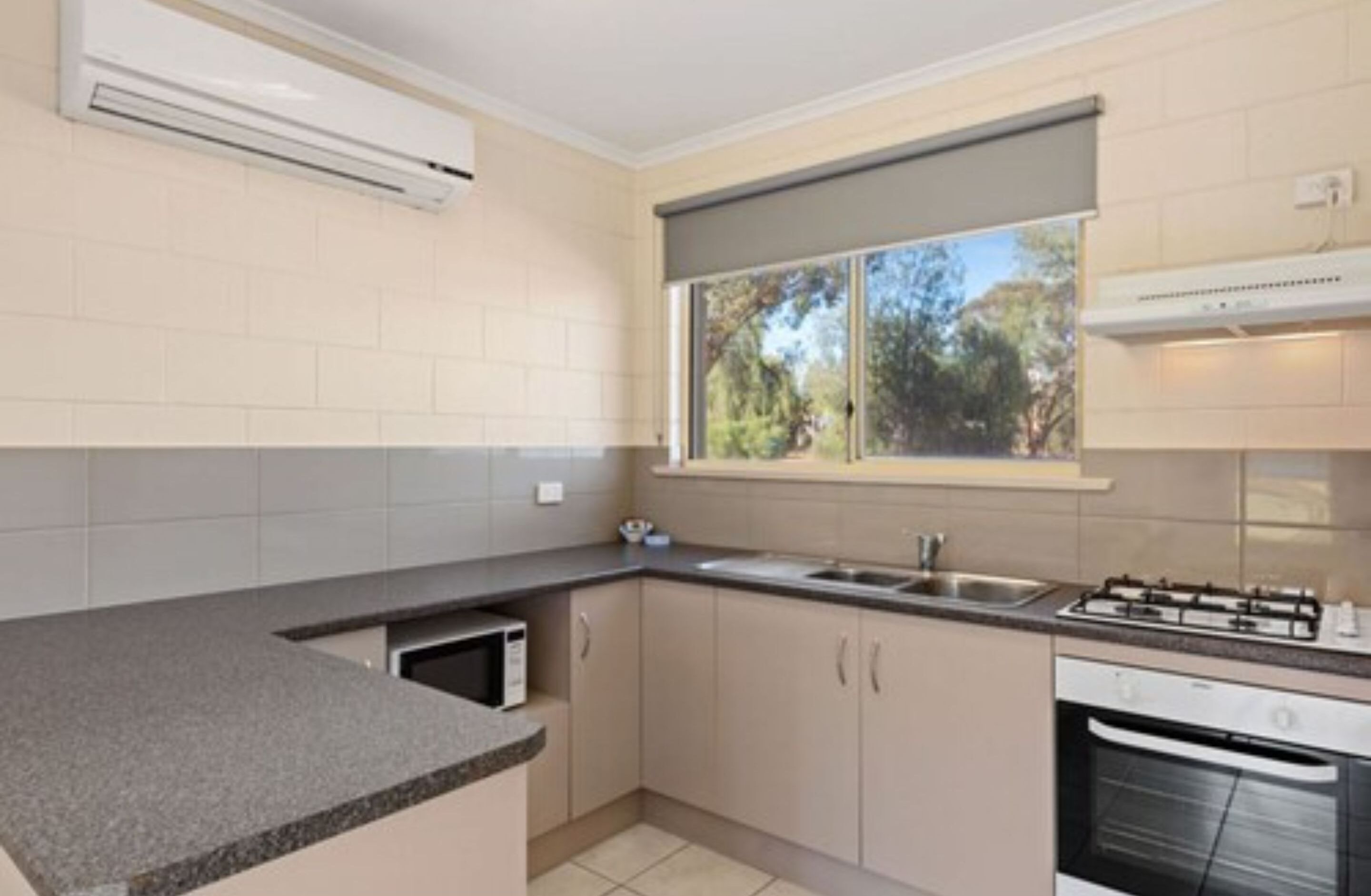 A modern kitchen with a built-in microwave, gas stove, and oven.