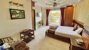 A hotel room with a bed, a desk with a telephone, a television, and a painting on the wall. - Dai Long Hotel (Da Nang)