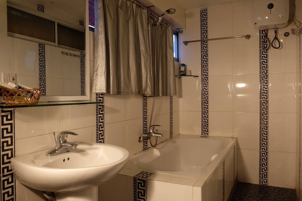 standard triple room | bathroom | deep-soaking bathtub, rainfall showerhead, free toiletries, hair dryer