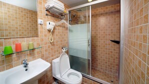 A bathroom with a sink, toilet, and glass shower enclosure. - Wonderful Inn (Kowloon)