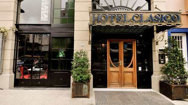 The exterior of HotelClasico with a classic facade, large arched windows, and a prominent entrance. - Hotel Clasico (Buenos Aires)