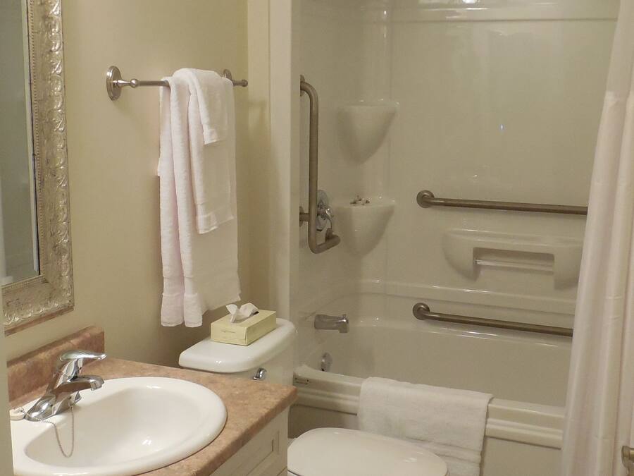 A bathroom with a sink, toilet, and shower.