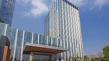 A modern building with a glass facade and a prominent vertical design.