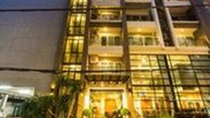 A multi-story hotel with a modern architectural design, featuring balconies and large windows. - Sea Me Spring Too Hotel (Pattaya)