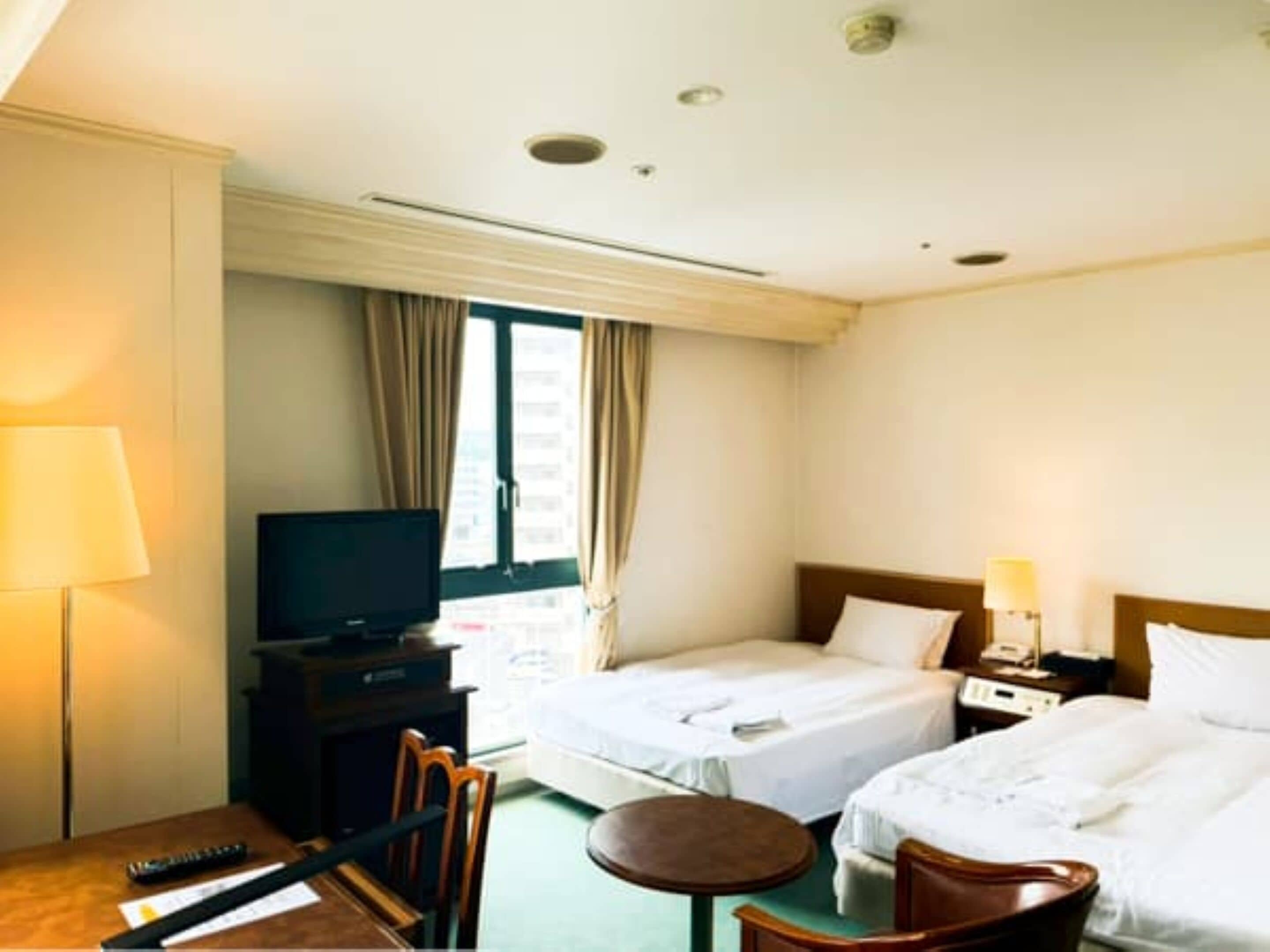 Twin Room | Desk, iron/ironing board (on request), WiFi (free), bed sheets