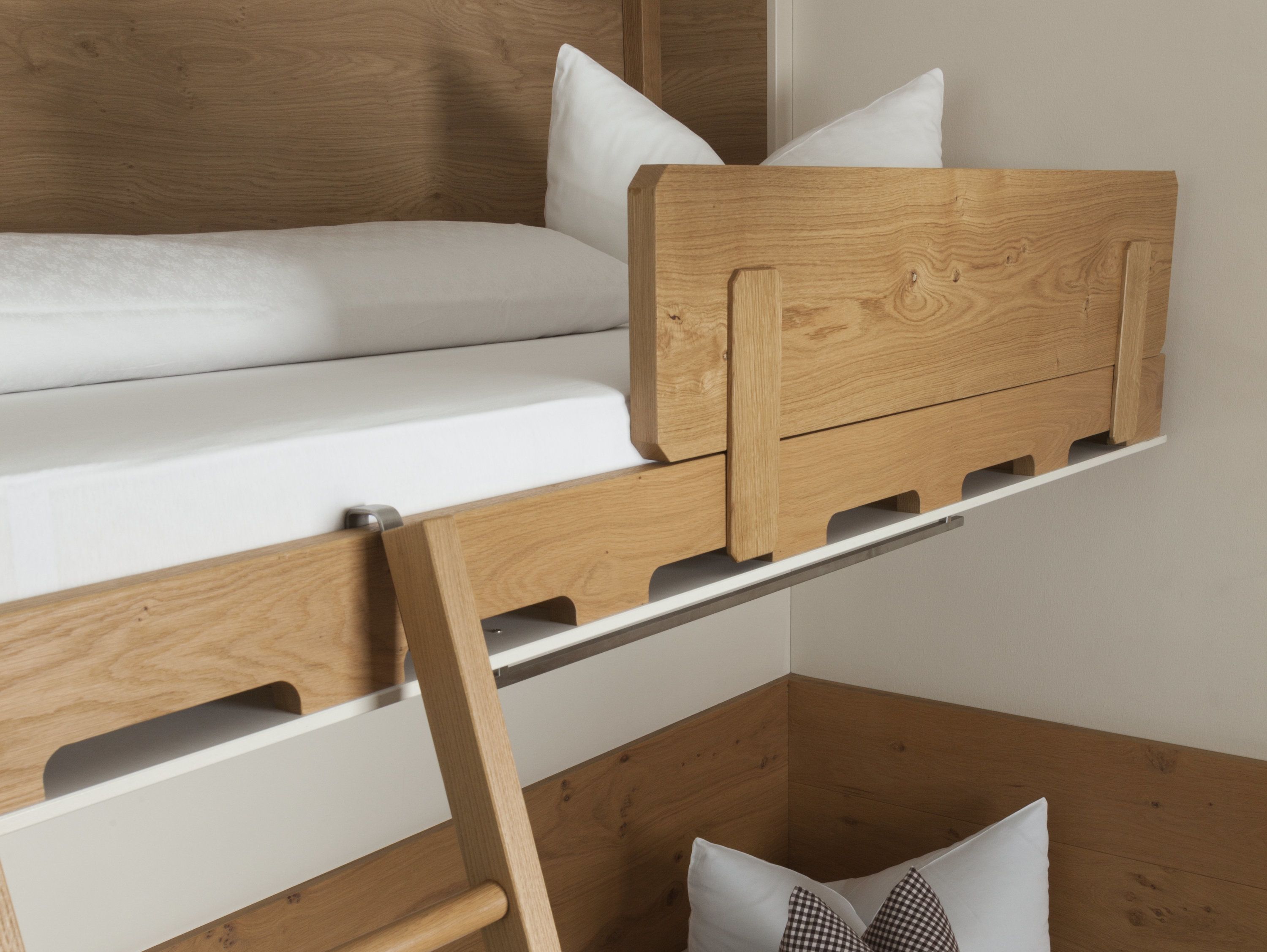 A bunk bed with a wooden headboard and white bedding.