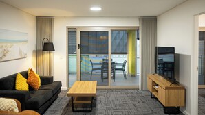A modern living room with a sofa, a wooden coffee table, a TV on a wooden stand, and a sliding glass door leading to an outdoor seating area. - Baileys Serviced Apartments (East Perth)