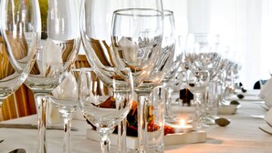 A row of empty wine glasses on a table, suggesting a formal dining setting. - Nötesjö Hotell (Svedala)