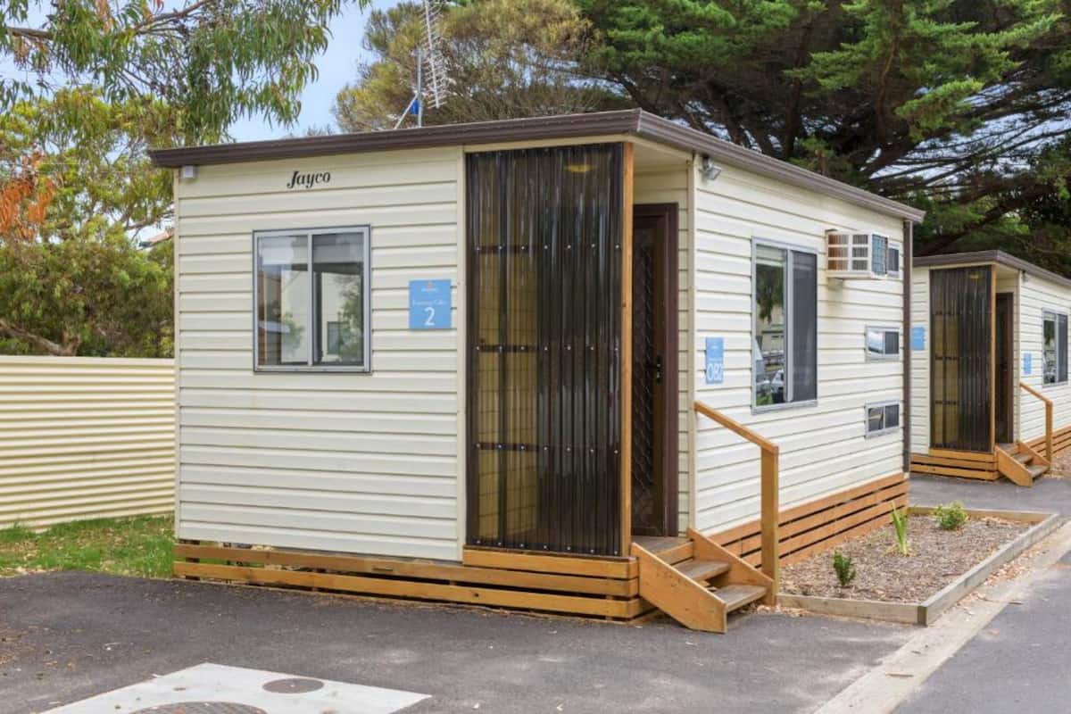 A mobile home with a nameplate 'Jayco' and numbered windows.