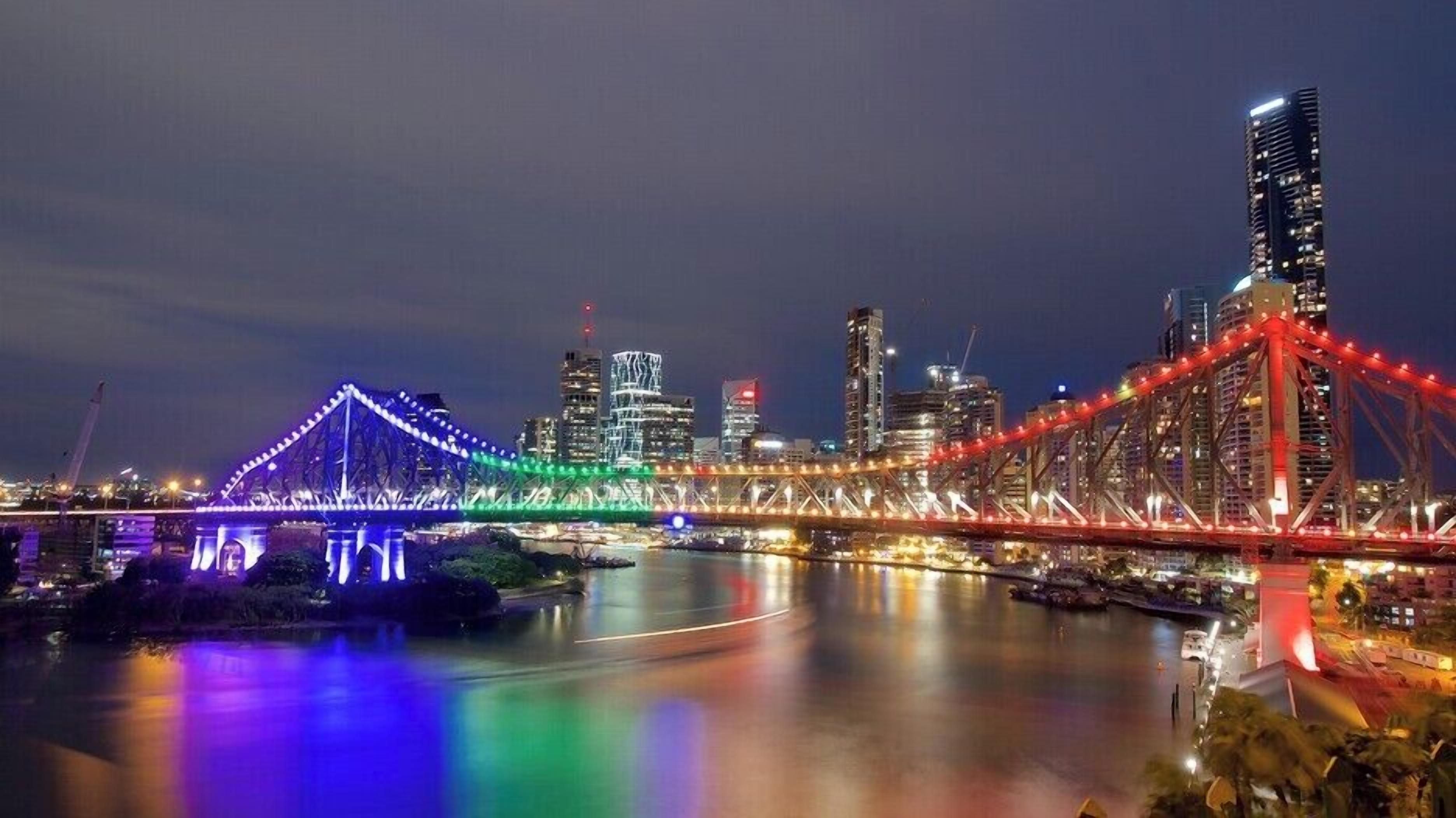 A cityscape with illuminated bridges and modern buildings.