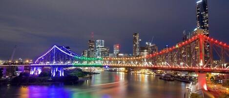 A cityscape with illuminated bridges and modern buildings.
