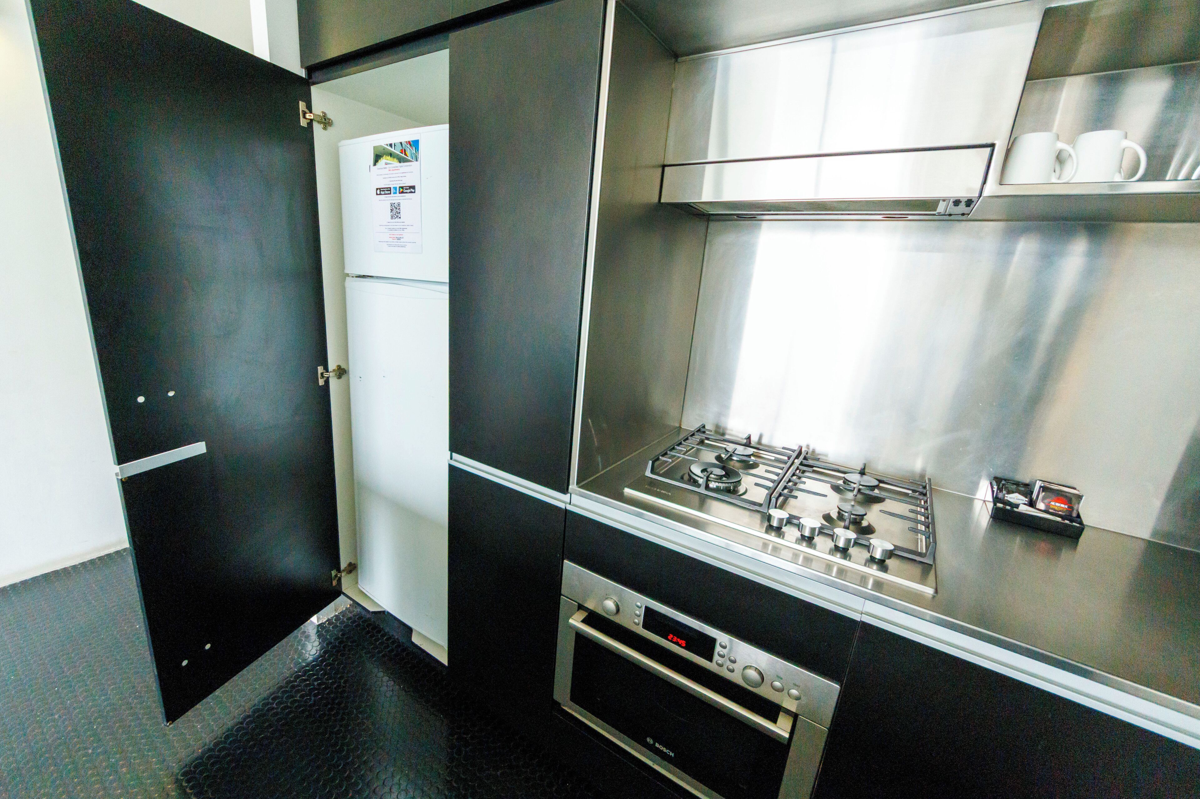 A compact kitchen with a gas stove, oven, and stainless steel appliances.