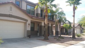 A residential house with a garage, a driveway, and palm trees. - Happy Valley House (Phoenix)