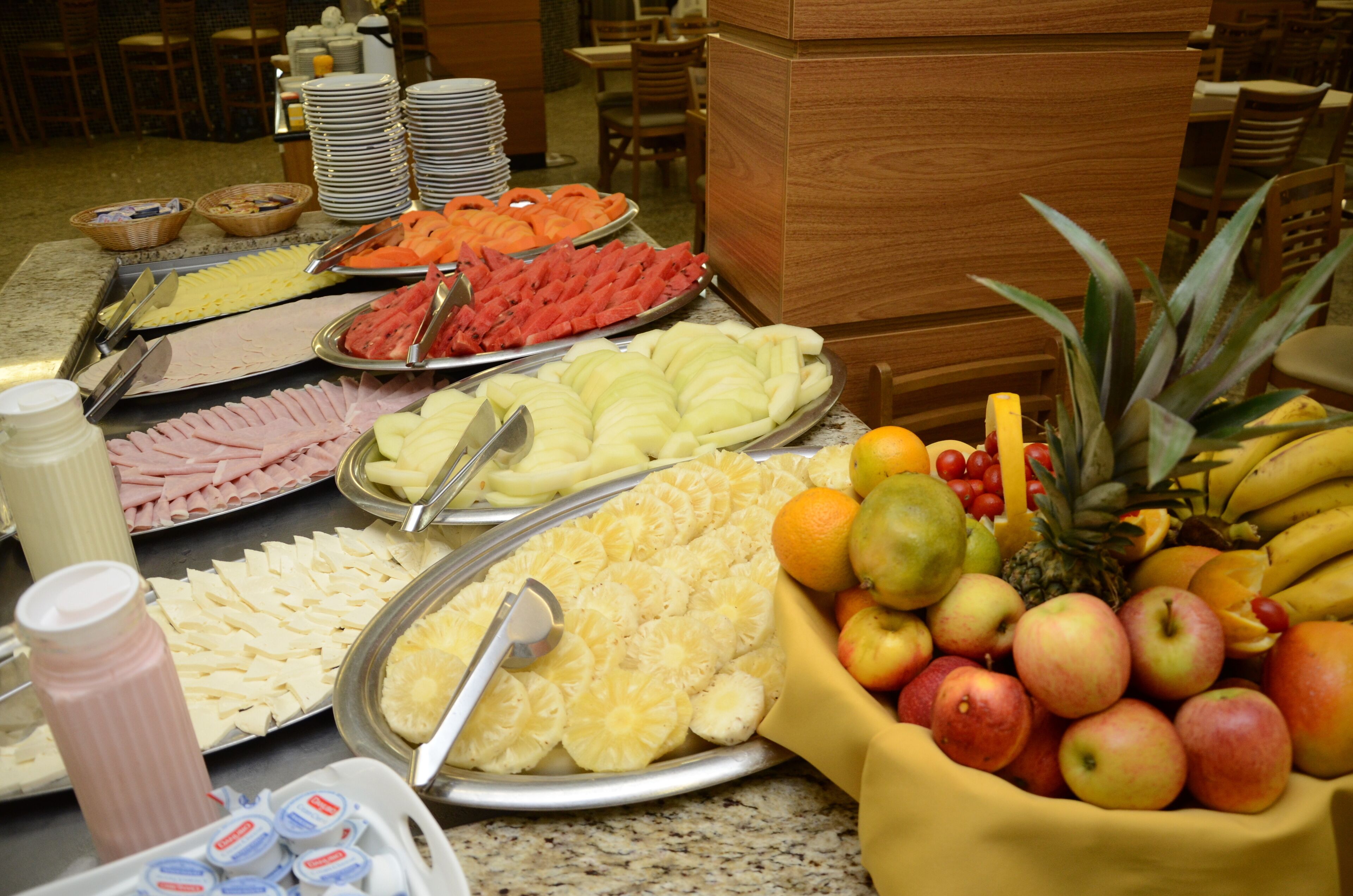A buffet with various fruits and cheeses.