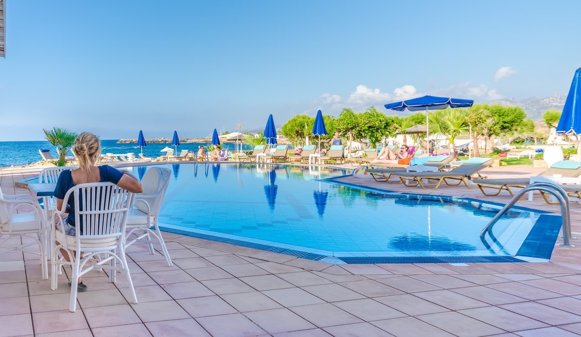 outdoor pool, open 8:00 am to 8:30 pm, pool umbrellas, pool loungers