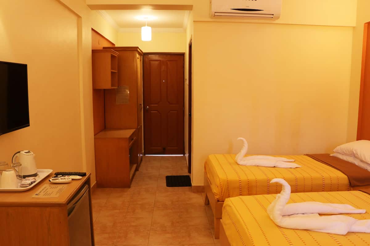 deluxe twin room, 2 single beds, non smoking, pool view | 1 bedroom, minibar, in-room safe, desk