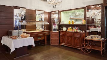A buffet setup with various food items and a wine cooler.