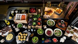 A top-down view of a buffet with various dishes, including meats, salads, and desserts.