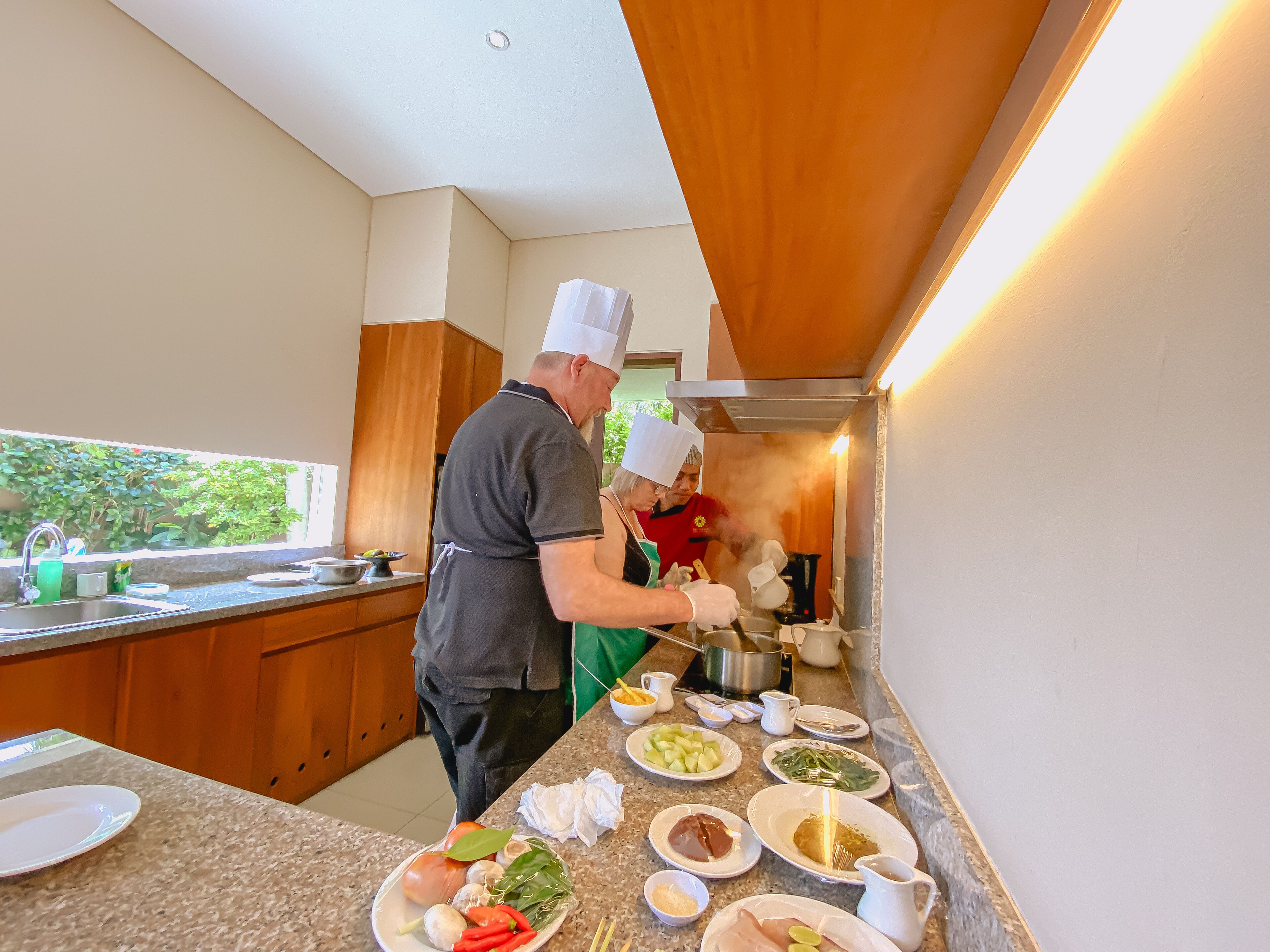 A modern kitchen with granite countertops, stainless steel appliances, and wooden cabinets.