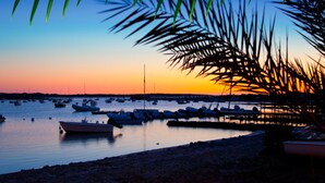 A marina at sunset with boats docked. - El Lago Dorado (Formentera)
