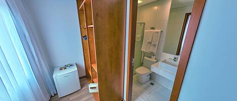 A modern bathroom with a toilet, sink, and mirror.