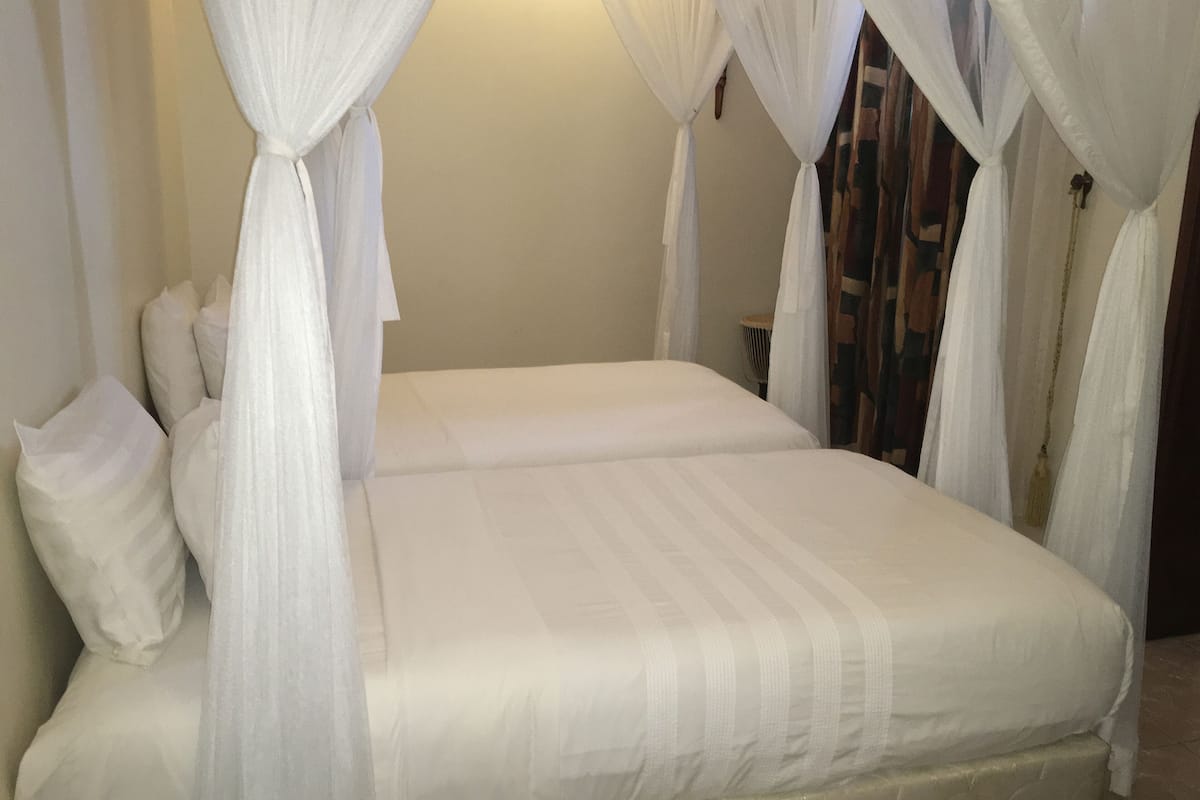 Premium bedding, desk, laptop workspace, blackout drapes