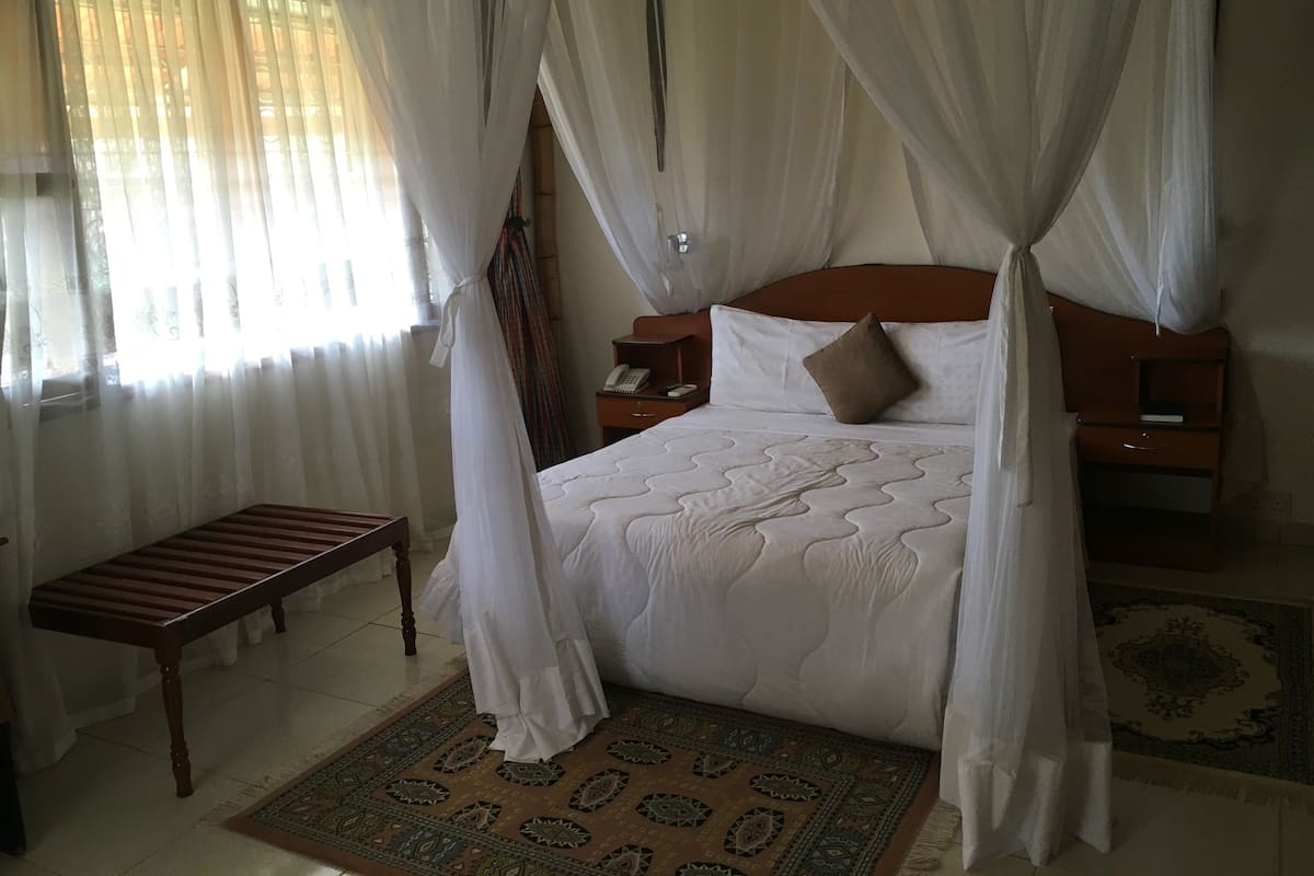 Premium bedding, desk, laptop workspace, blackout drapes