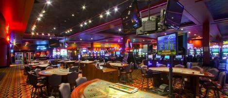 A casino with multiple gaming tables and slot machines.