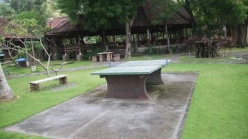 A park with a ping pong table, benches, and a gazebo.