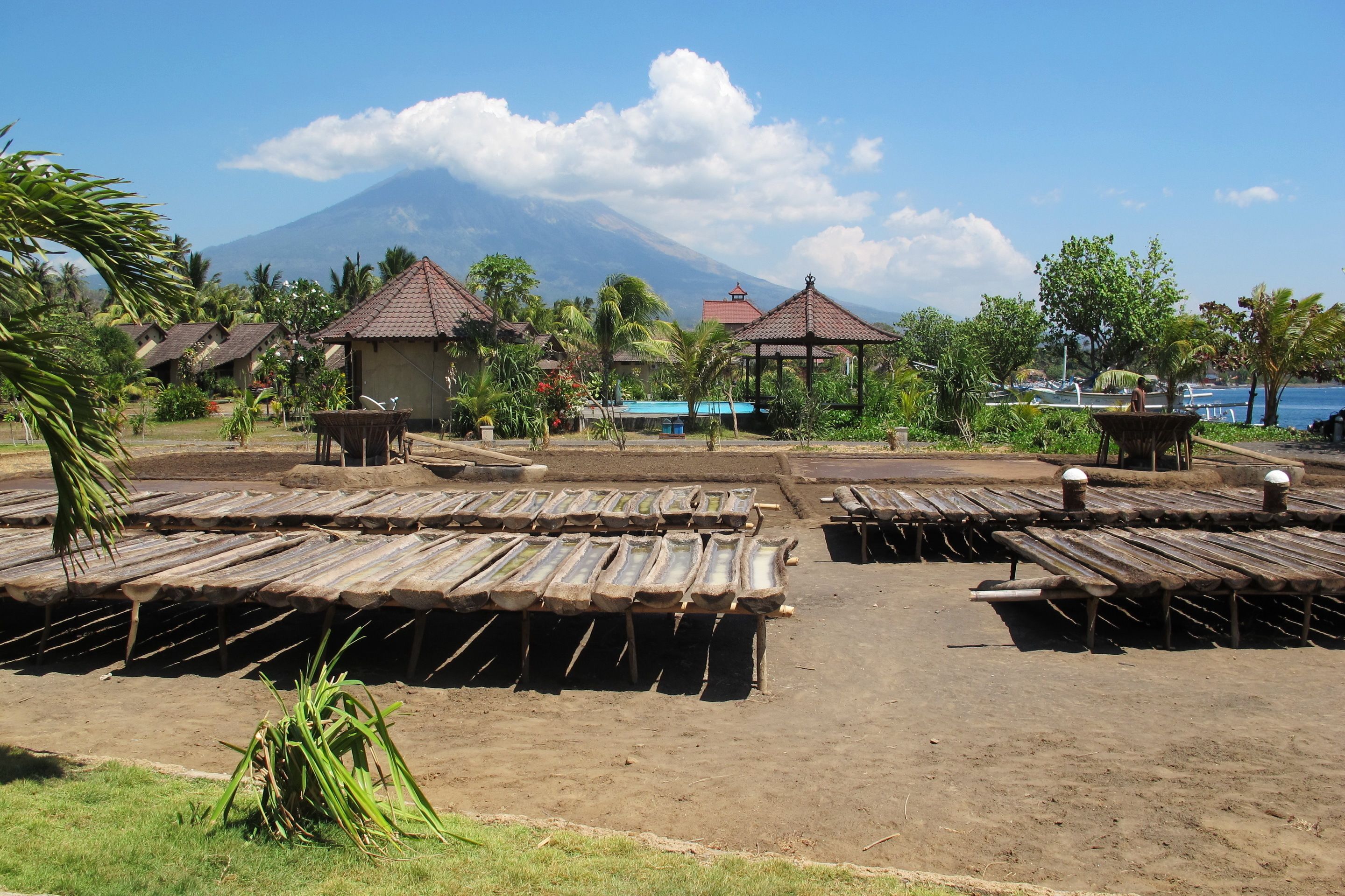 A resort with wooden deck seating, a pool, and a mountain view.