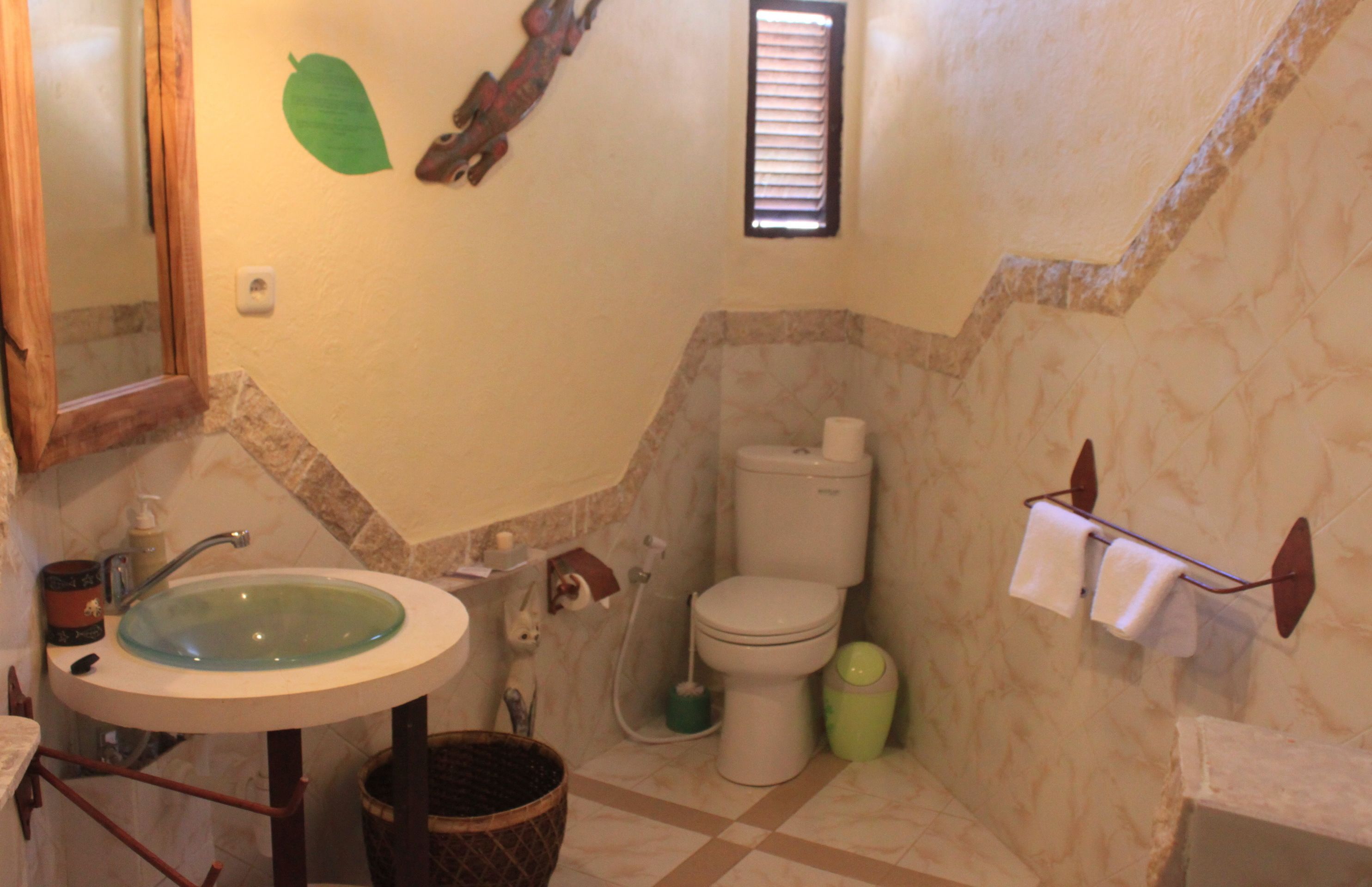 A bathroom with a sink, toilet, and shower.