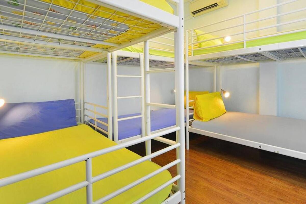 A bunk bed room with two beds, each with a mattress and pillow.