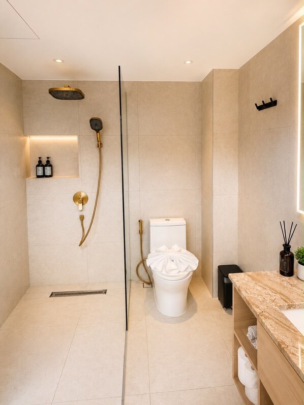 A modern bathroom with a shower, toilet, and vanity.