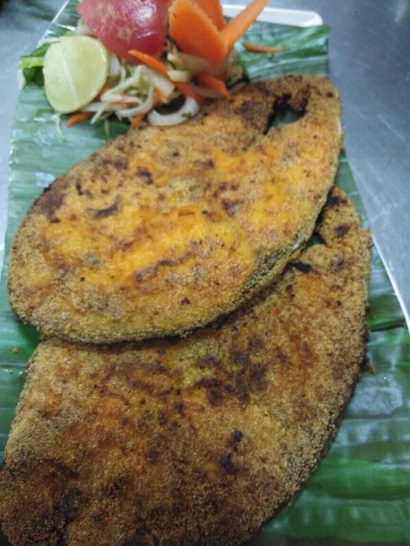Two breaded fish patties on a green leaf. - Boshan Hotels (Mapusa)