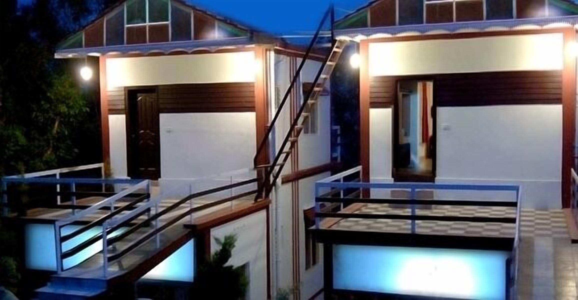 A modern two-story house with a covered porch, a visible staircase, and a garage door.