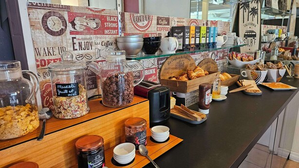 A breakfast buffet with various food items and coffee options. - Brit Hotel Essentiel Pau Lescar (Lescar)