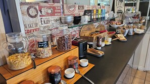 A breakfast buffet with various food items and condiments. - Brit Hotel Essentiel Pau Lescar (Lescar)