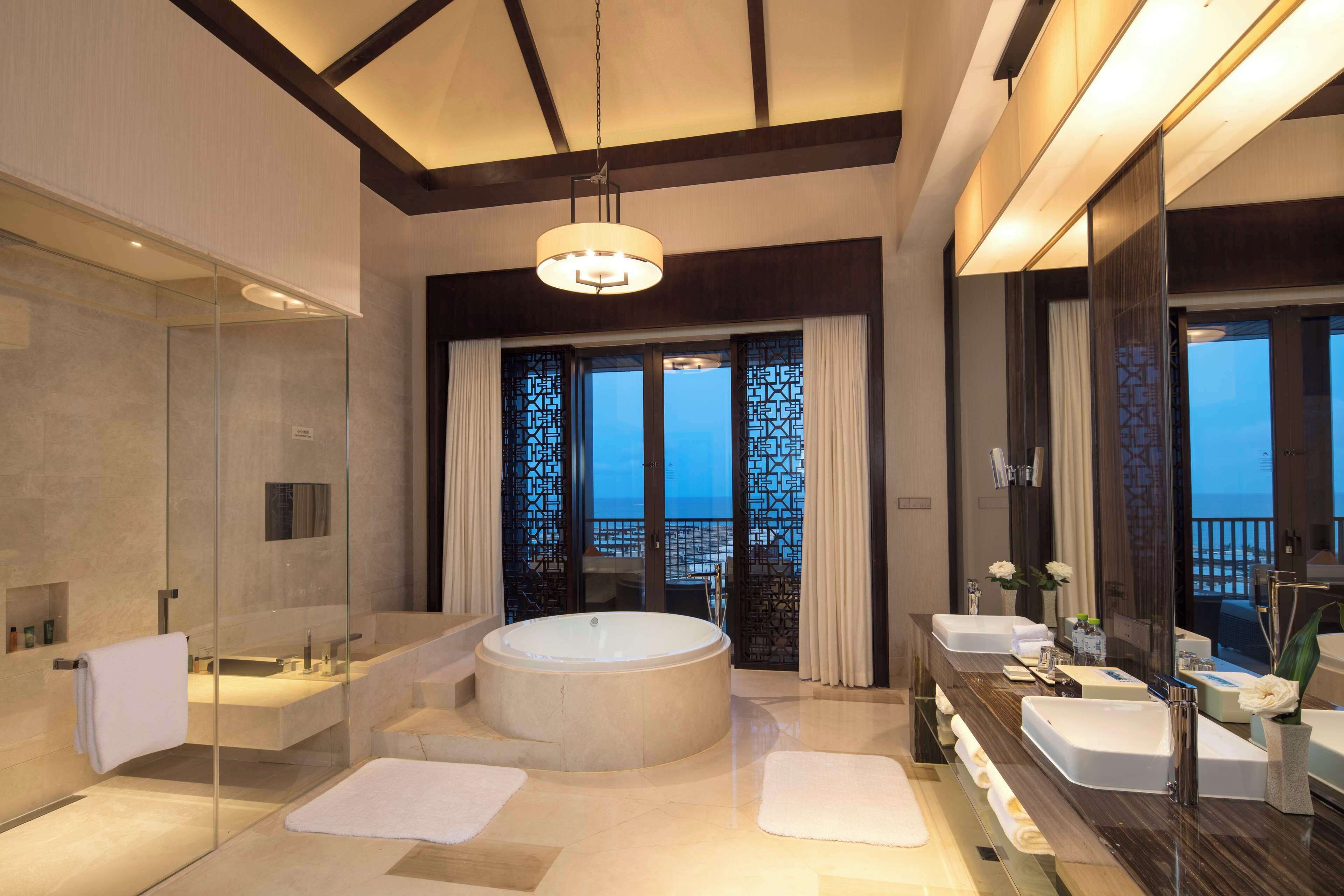 two bedroom presidential suite | bathroom | separate bathtub and shower, rainfall showerhead, hair dryer, bathrobes