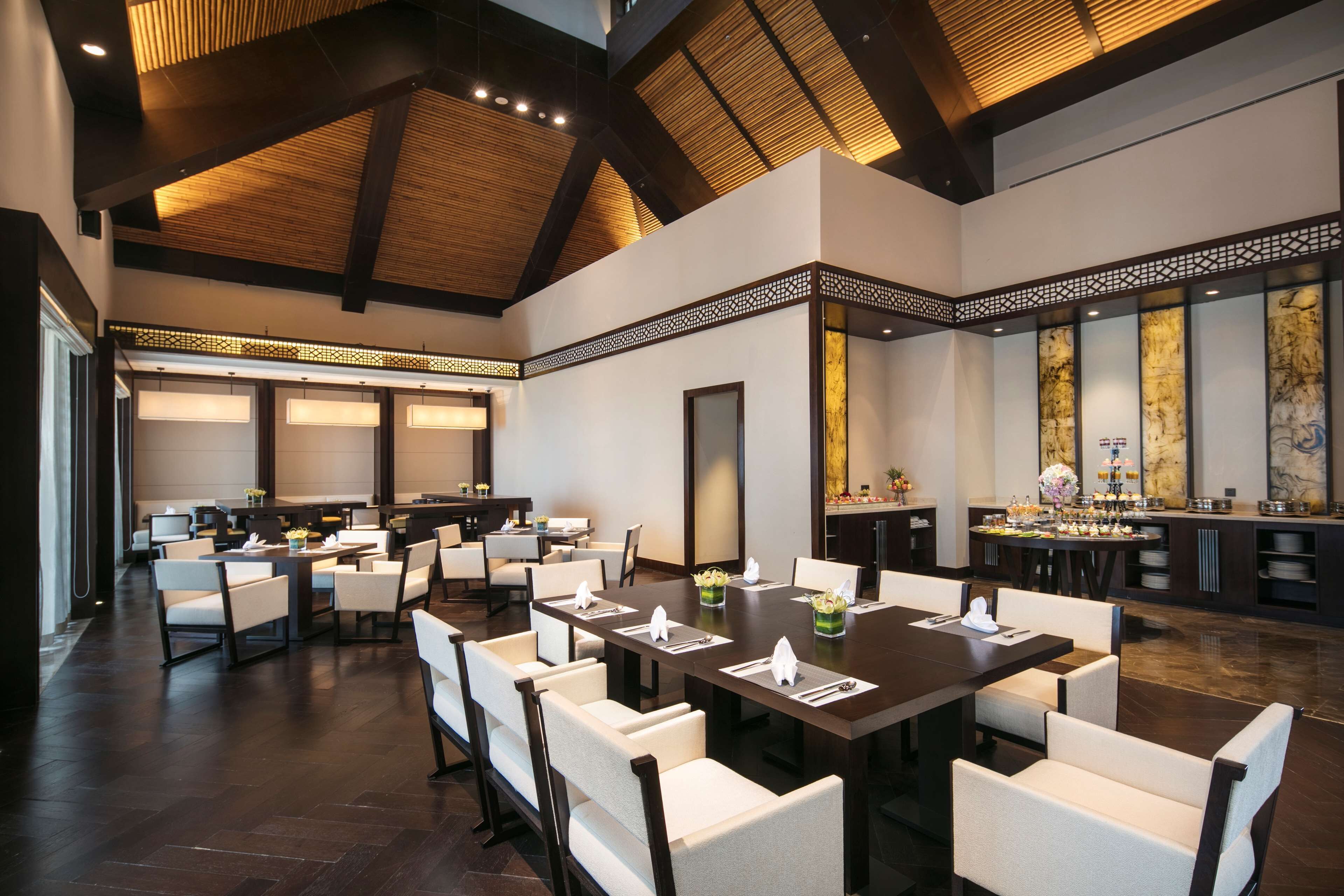 A spacious dining area with high ceilings and modern lighting.
