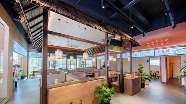 A modern interior with a reception desk, seating areas, and potted plants. - Yiaihu Hotel (Huanggang)