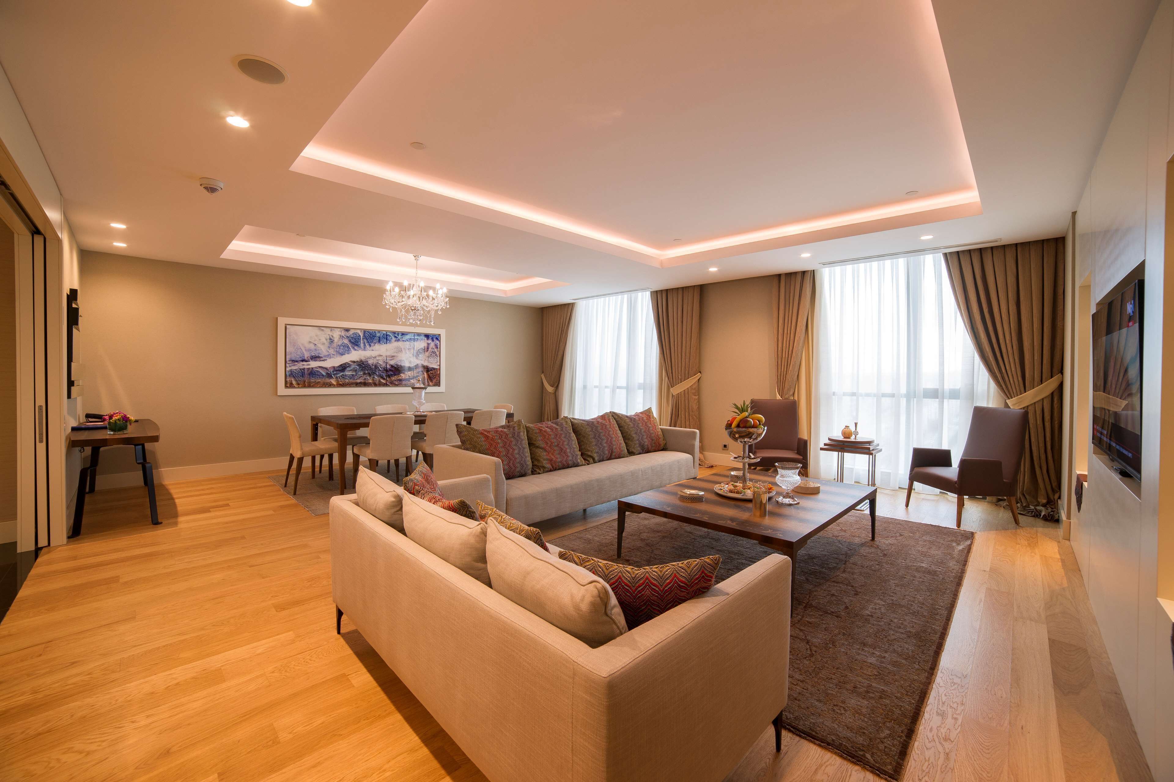 A modern living room with a sofa, coffee table, and dining area.